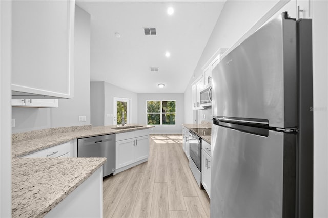 kitchen with white cabinets, sink, light hardwood / wood-style flooring, light stone counters, and stainless steel appliances