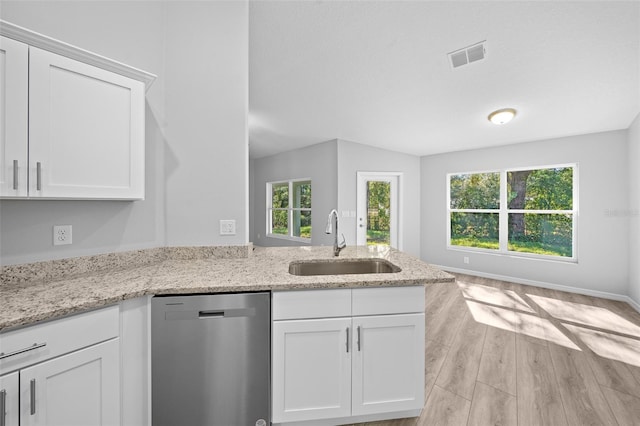 kitchen with stainless steel dishwasher, light hardwood / wood-style floors, white cabinetry, and sink