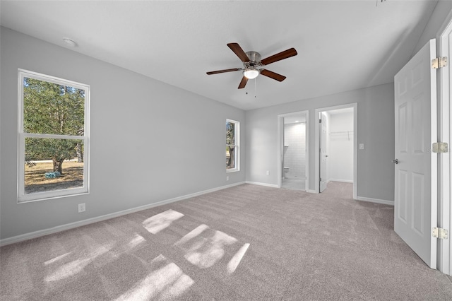 19662 SW Marine Blvd, Dunnellon, FL 34431 - unfurnished bedroom featuring carpet flooring, a spacious closet, ensuite bathroom, ceiling fan, and a closet
