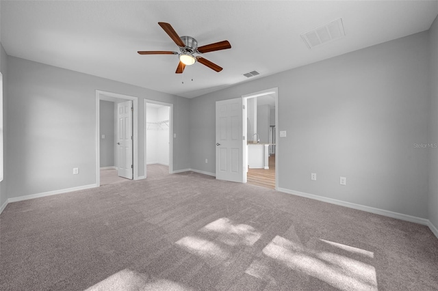 19662 SW Marine Blvd, Dunnellon, FL 34431 - unfurnished bedroom featuring light carpet, a spacious closet, ceiling fan, and a closet