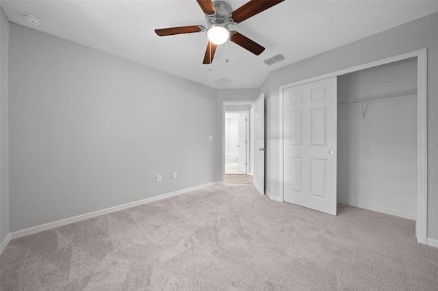 unfurnished bedroom featuring ceiling fan, a closet, and light colored carpet