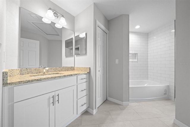 bathroom featuring tile patterned flooring, vanity, and tiled shower / bath