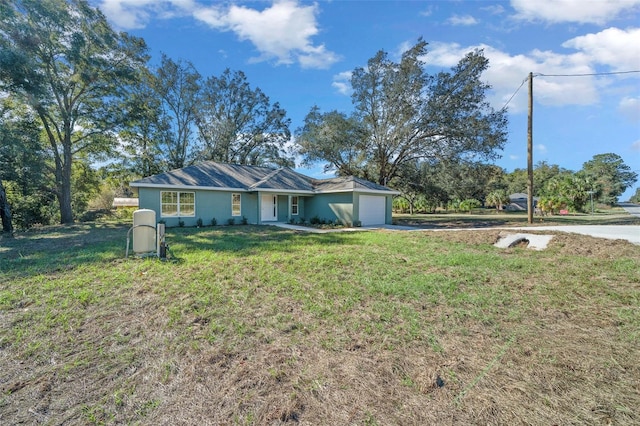 ranch-style home featuring a front yard and a garage