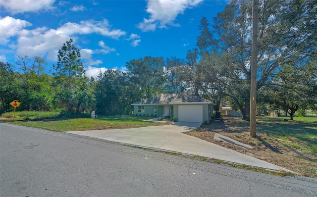 single story home with a front yard and a garage