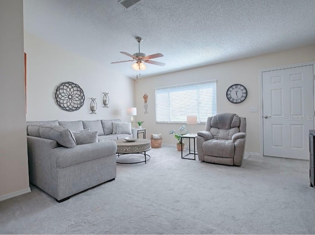 living room featuring carpet, ceiling fan, and a textured ceiling