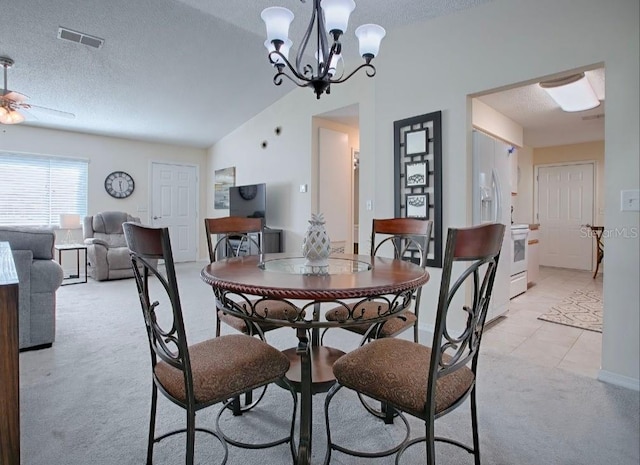 carpeted dining room featuring lofted ceiling, a textured ceiling, and ceiling fan with notable chandelier