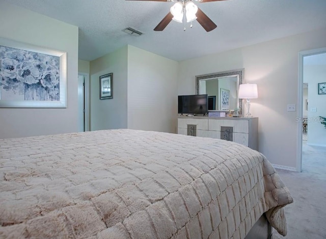 bedroom featuring carpet, a textured ceiling, and ceiling fan