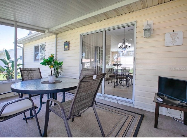 10783 SE 178th St, Summerfield, FL 34491 - sunroom featuring outdoor dining space and a notable chandelier