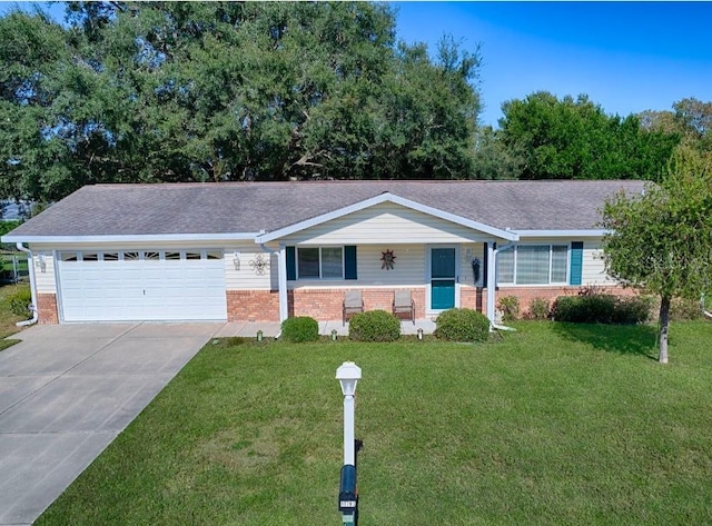 10783 SE 178th St, Summerfield, FL 34491 - ranch-style home featuring a garage, covered porch, a front yard, brick siding, and driveway