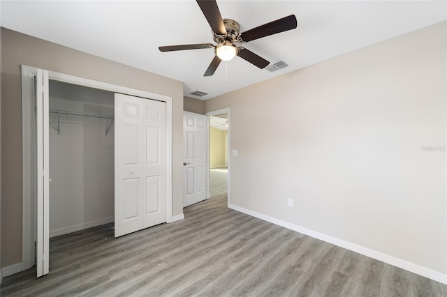 unfurnished bedroom featuring a closet, ceiling fan, and light hardwood / wood-style flooring