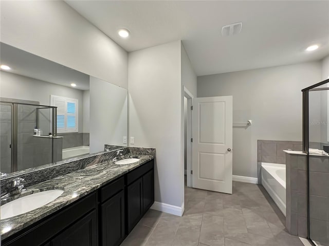 bathroom featuring vanity, plus walk in shower, and tile patterned floors