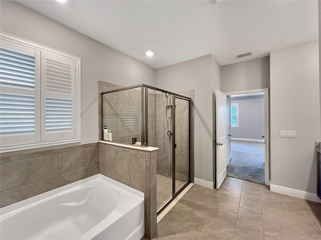 bathroom with a stall shower, recessed lighting, baseboards, visible vents, and a bath