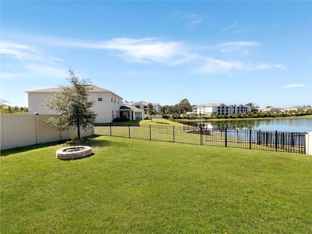 view of yard featuring a water view and a fire pit