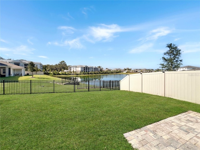 view of yard featuring a patio area and a water view