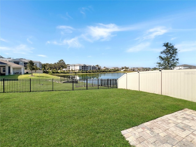 view of yard with a water view and a fenced backyard