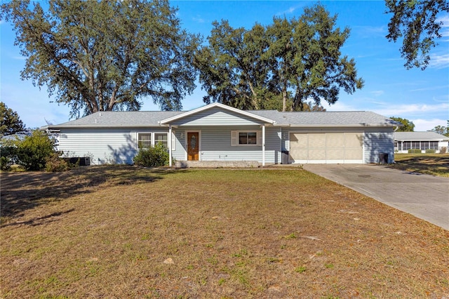 ranch-style house with a front yard and a garage