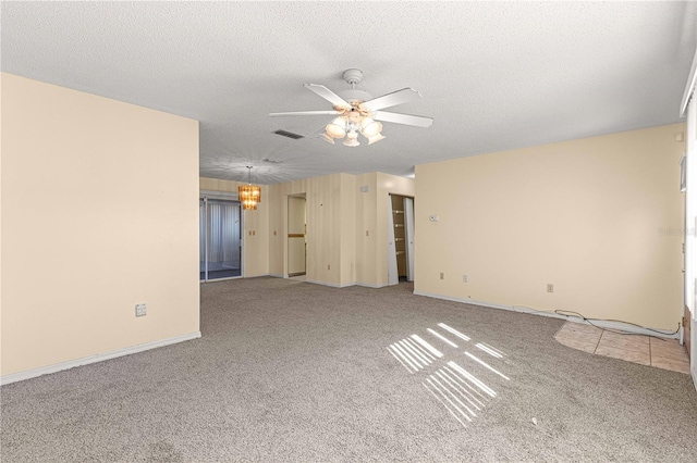 carpeted spare room with ceiling fan with notable chandelier and a textured ceiling