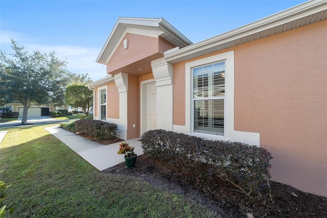 entrance to property with a lawn