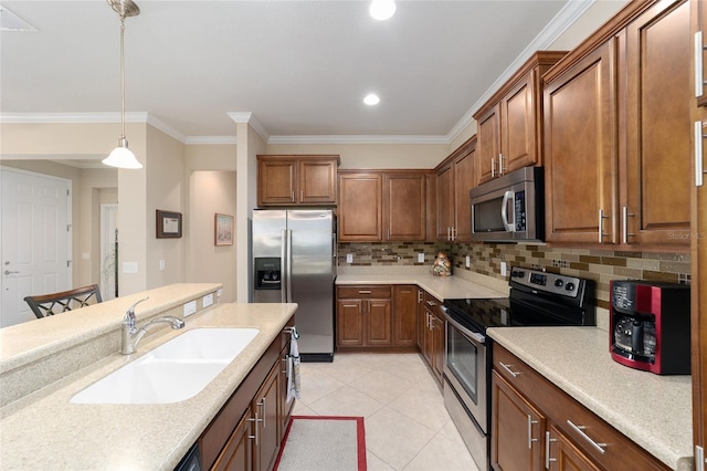 kitchen with appliances with stainless steel finishes, sink, backsplash, pendant lighting, and crown molding