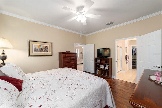 bedroom with crown molding, dark hardwood / wood-style floors, and ceiling fan