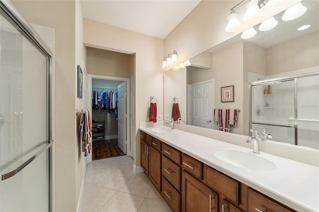 bathroom with vanity, a shower with shower door, and tile patterned floors