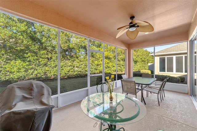 sunroom featuring ceiling fan