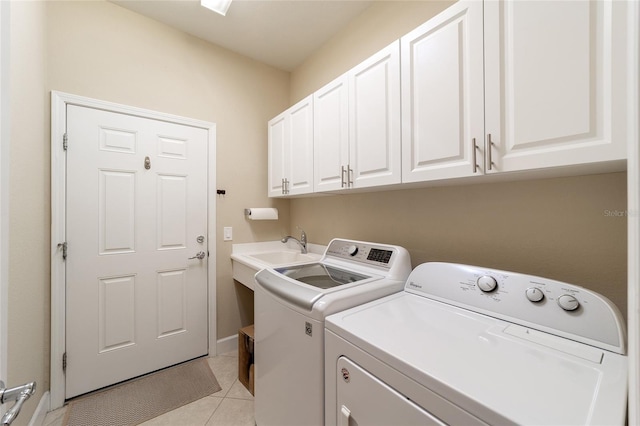 washroom with cabinets, sink, separate washer and dryer, and light tile patterned floors