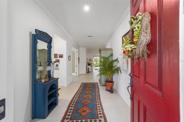 hall featuring ornamental molding and light tile patterned floors