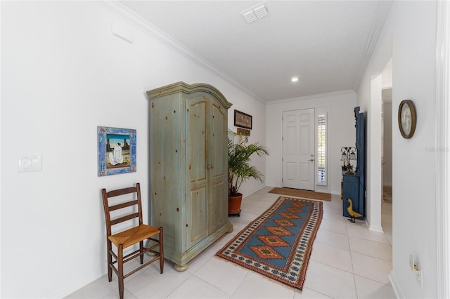 foyer featuring crown molding and light tile patterned flooring