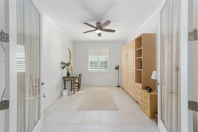 interior space with ornamental molding, a textured ceiling, and light tile patterned floors