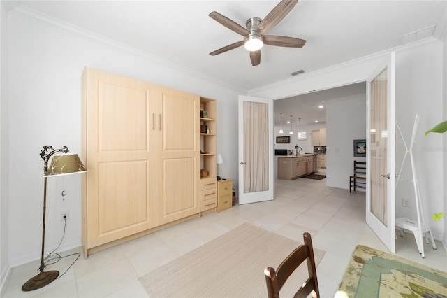 bedroom featuring french doors, ornamental molding, and light tile patterned floors