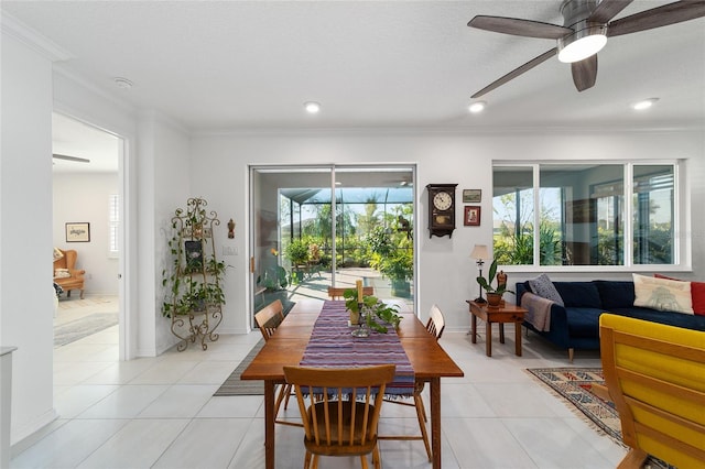 tiled dining area featuring ornamental molding, a textured ceiling, and ceiling fan