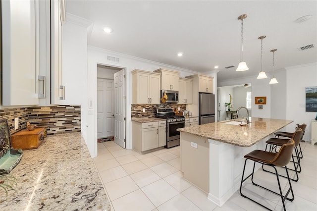 kitchen with hanging light fixtures, stainless steel appliances, backsplash, sink, and light stone countertops