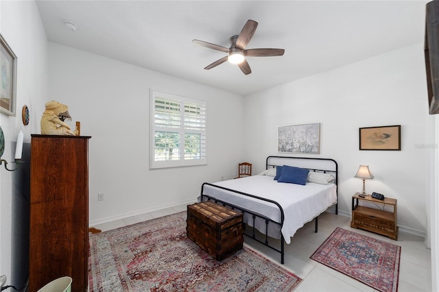 bedroom featuring light tile patterned flooring and ceiling fan