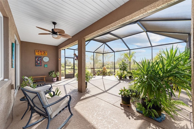 view of patio featuring a lanai and ceiling fan