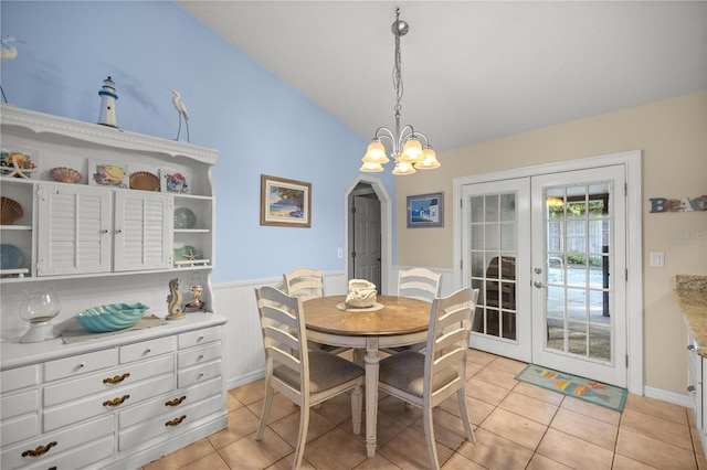 tiled dining space with french doors and an inviting chandelier