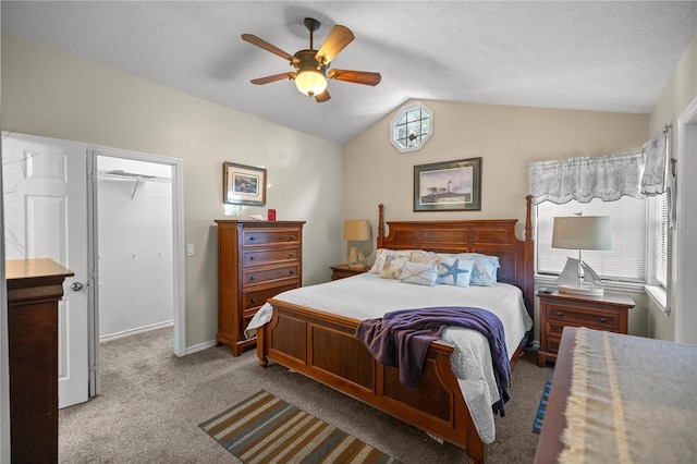 bedroom featuring vaulted ceiling, light carpet, ceiling fan, a closet, and a spacious closet