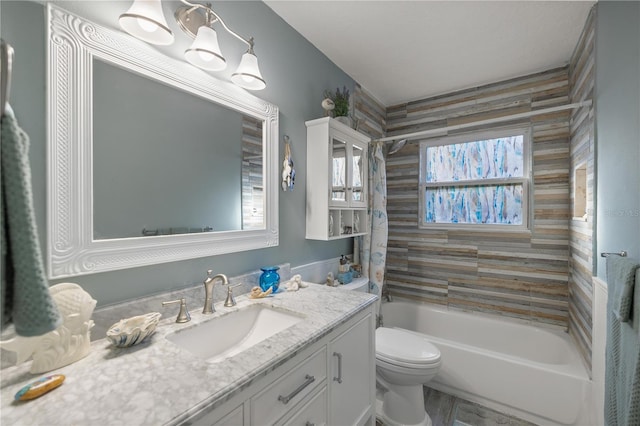 full bathroom featuring vanity, a healthy amount of sunlight, toilet, and tiled shower / bath combo