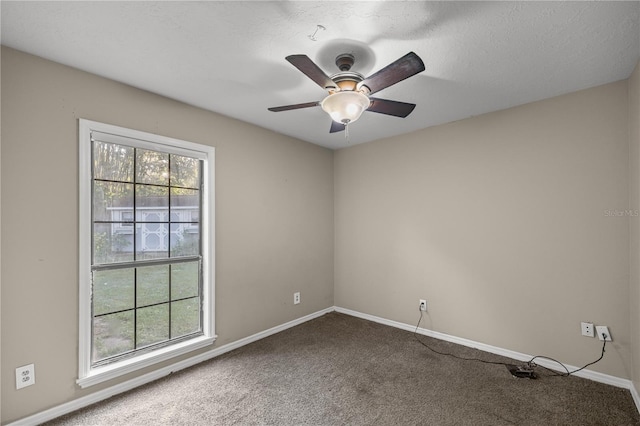 carpeted empty room featuring a wealth of natural light, ceiling fan, and a textured ceiling