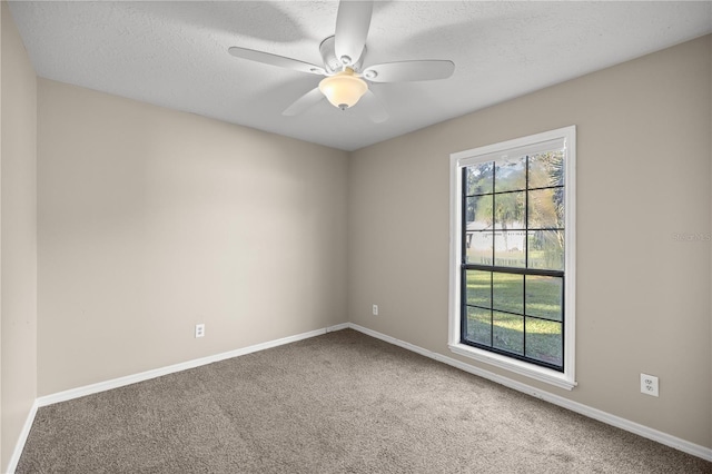 spare room featuring ceiling fan, a textured ceiling, and carpet flooring