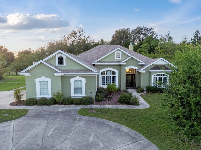 single story home featuring a front yard