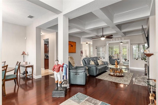 living room featuring crown molding, dark hardwood / wood-style flooring, ceiling fan, coffered ceiling, and beam ceiling