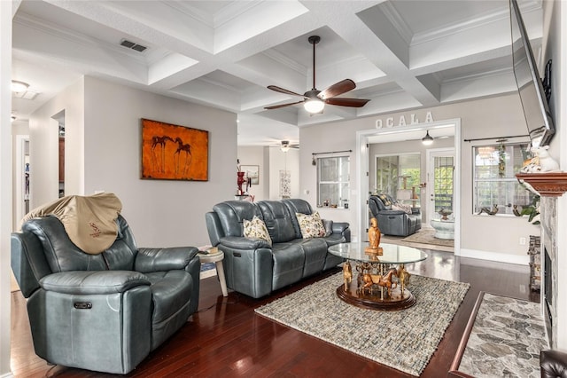 living room featuring dark hardwood / wood-style flooring, ceiling fan, coffered ceiling, beamed ceiling, and ornamental molding