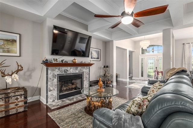 living room with a premium fireplace, crown molding, ceiling fan with notable chandelier, and dark hardwood / wood-style flooring