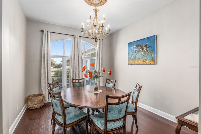 dining area with an inviting chandelier and dark hardwood / wood-style floors