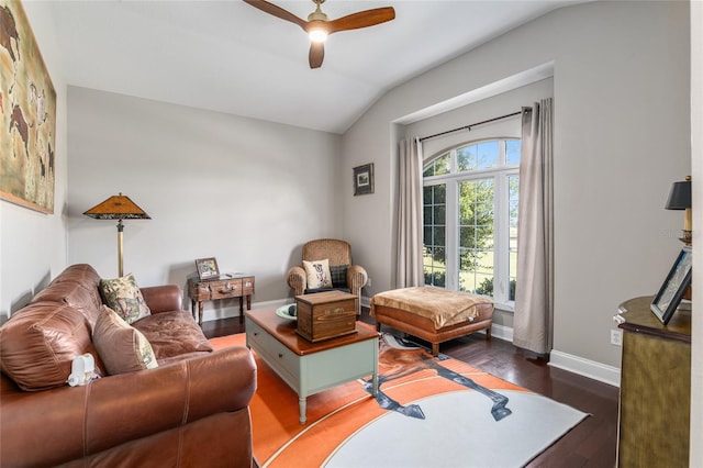 living room featuring dark wood-type flooring, vaulted ceiling, and ceiling fan