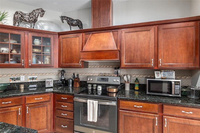 kitchen featuring dark stone countertops, tasteful backsplash, stainless steel appliances, and a textured ceiling