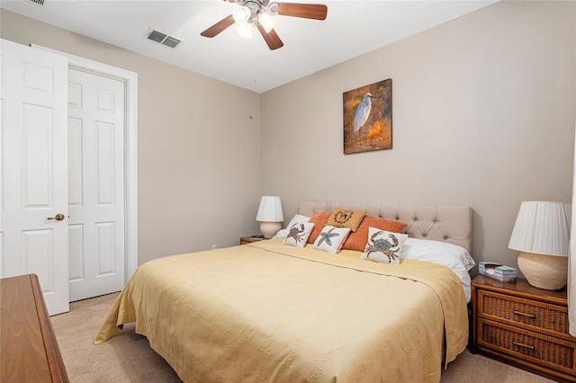 bedroom featuring a closet, light carpet, and ceiling fan