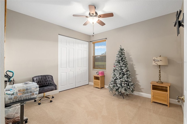 office space with light carpet and ceiling fan