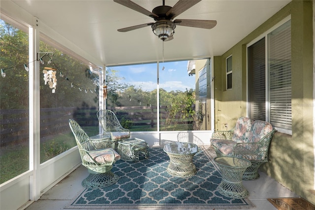 sunroom / solarium featuring ceiling fan